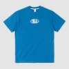 Oli X Badge Tee | Rusty Hot